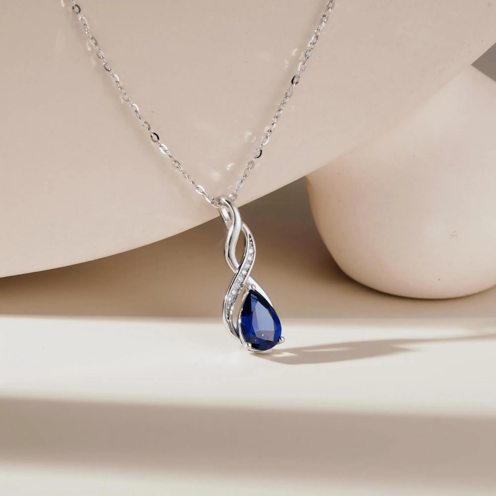 1.56 CT. Blue Sapphire and White Sapphire Infinity Swirl Pendant