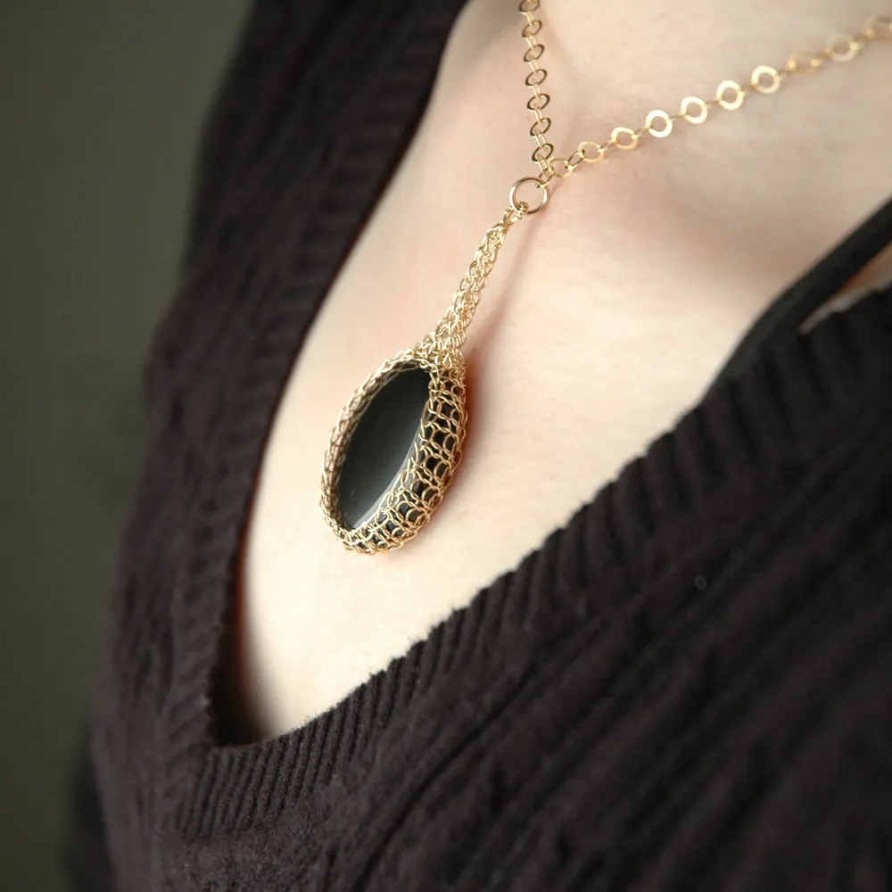 Black Onyx  pendant necklace, nested in gold wire crochet